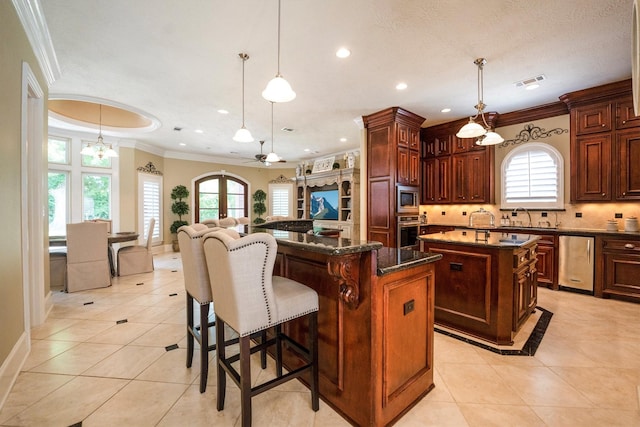 3610 Pembrooke Dr, Richmond, TX 77406 - kitchen featuring stainless steel appliances, a kitchen island, ornamental molding, light tile patterned floors, and recessed lighting