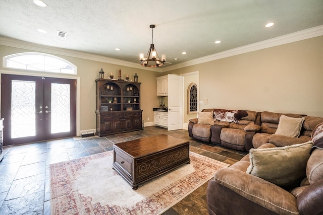 3610 Pembrooke Dr, Richmond, TX 77406 - living room featuring a chandelier, crown molding, stone tile flooring, french doors, and recessed lighting