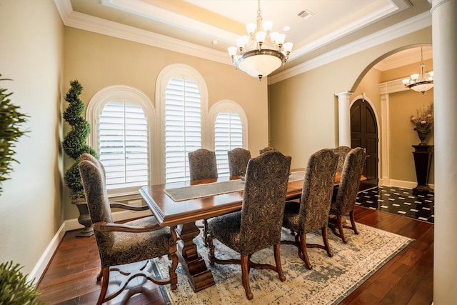 3610 Pembrooke Dr, Richmond, TX 77406 - dining area with a chandelier, arched walkways, a raised ceiling, ornamental molding, and dark wood-style floors
