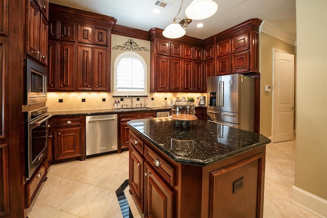 3610 Pembrooke Dr, Richmond, TX 77406 - kitchen featuring appliances with stainless steel finishes, ornamental molding, light tile patterned flooring, decorative light fixtures, and a center island