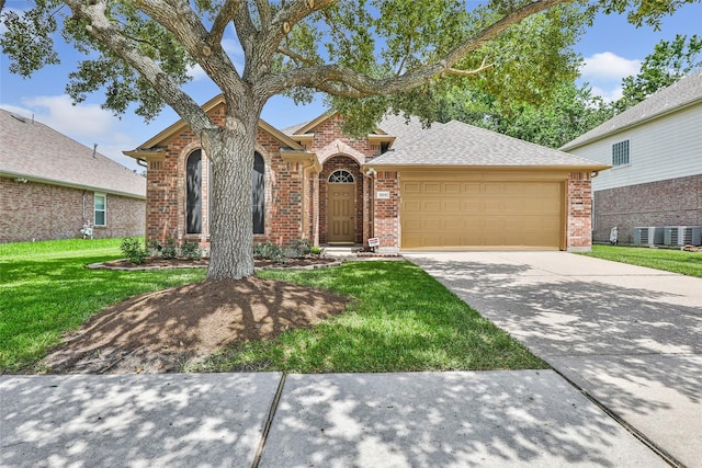 18618 Atascocita Forest Dr, Humble, TX 77346 - view of front of home featuring brick siding, an attached garage, a front yard, concrete driveway, and roof with shingles