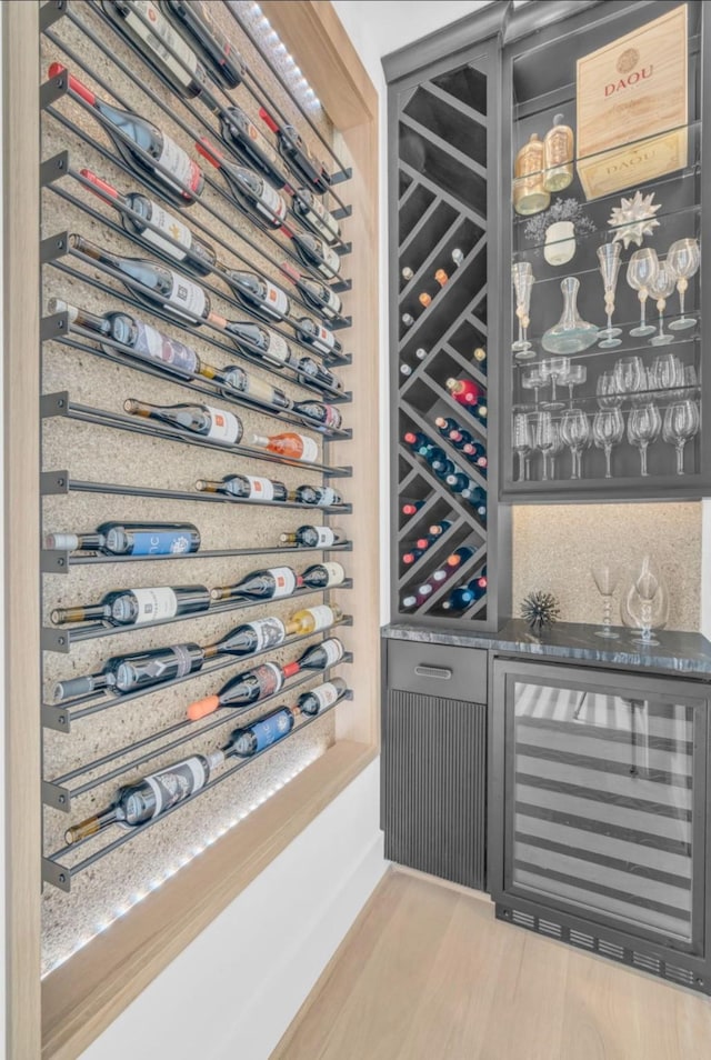 5602 Ella Lee Ln, Houston, TX 77056 - wine area featuring wine cooler, a dry bar, and light wood-style flooring