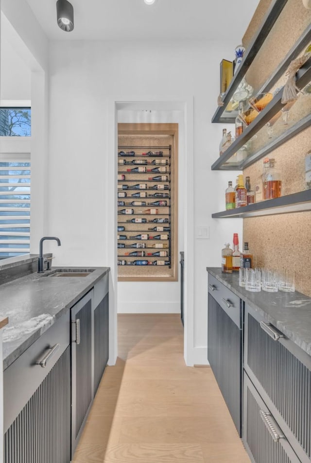 5602 Ella Lee Ln, Houston, TX 77056 - bar featuring a sink and light wood-type flooring