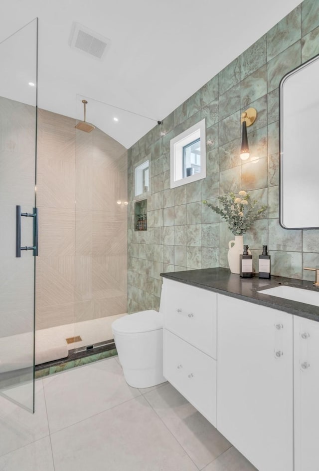 5602 Ella Lee Ln, Houston, TX 77056 - full bathroom featuring tile walls, a tile shower, vanity, and tile patterned flooring