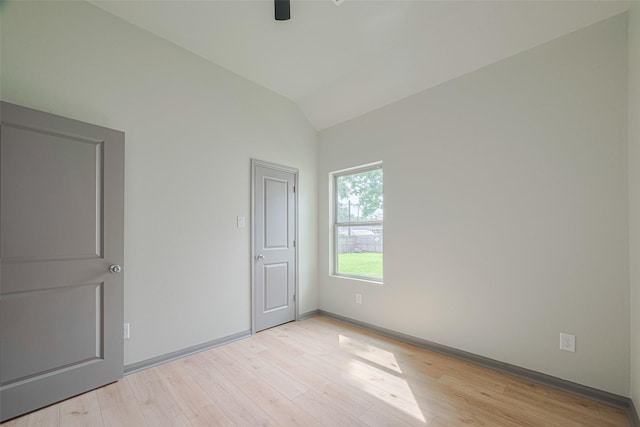 1909 Oregon St, Baytown, TX 77520 - unfurnished bedroom with vaulted ceiling, light wood-style flooring, and ceiling fan