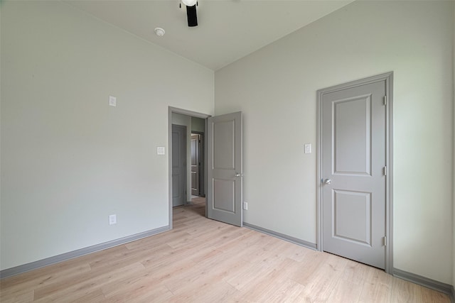 1909 Oregon St, Baytown, TX 77520 - unfurnished bedroom featuring light wood-type flooring, a ceiling fan, and lofted ceiling