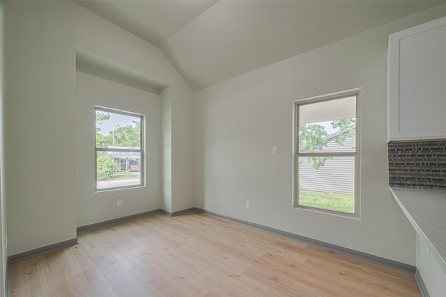 1909 Oregon St, Baytown, TX 77520 - unfurnished room featuring light wood-type flooring and lofted ceiling