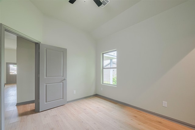 1909 Oregon St, Baytown, TX 77520 - unfurnished bedroom featuring lofted ceiling, light wood-type flooring, and a ceiling fan