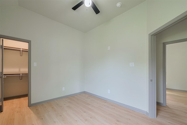 1909 Oregon St, Baytown, TX 77520 - unfurnished bedroom with vaulted ceiling, a walk in closet, light wood-type flooring, a closet, and a ceiling fan