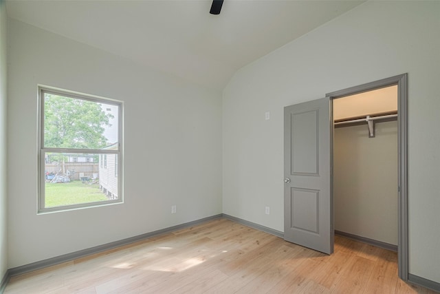 1909 Oregon St, Baytown, TX 77520 - unfurnished bedroom with multiple windows, light wood-type flooring, vaulted ceiling, a closet, and ceiling fan