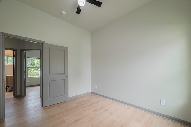 1909 Oregon St, Baytown, TX 77520 - empty room with ceiling fan, light wood finished floors, a smoke detector, and vaulted ceiling