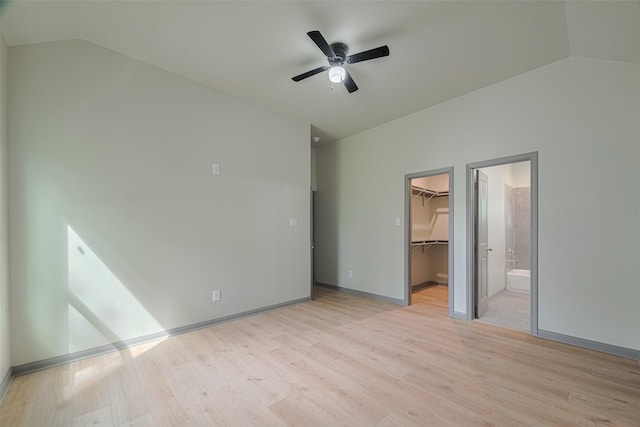 1909 Oregon St, Baytown, TX 77520 - unfurnished bedroom with vaulted ceiling, a walk in closet, light wood-type flooring, a closet, and a ceiling fan
