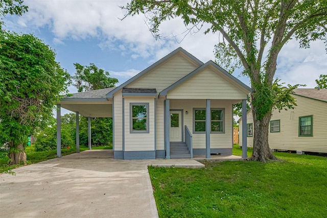 1909 Oregon St, Baytown, TX 77520 - bungalow-style home with concrete driveway, a front yard, a carport, entry steps, and a shingled roof