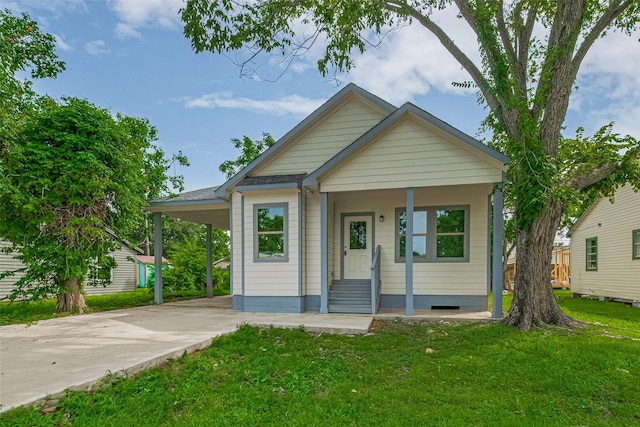 1909 Oregon St, Baytown, TX 77520 - view of front of house with driveway, a front yard, a carport, and entry steps