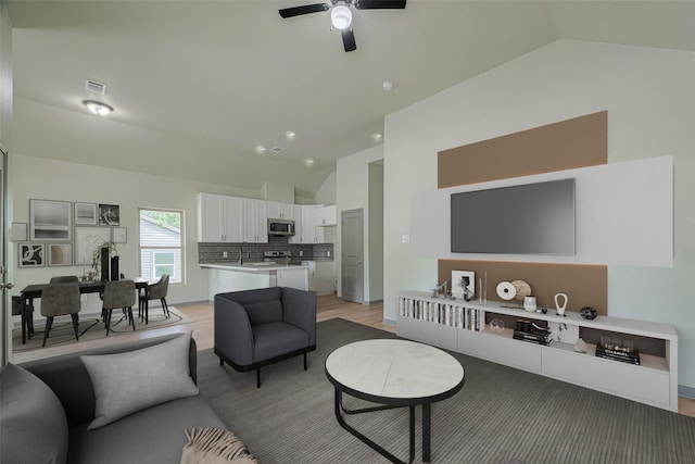 1909 Oregon St, Baytown, TX 77520 - living area with light wood-type flooring, a ceiling fan, and high vaulted ceiling
