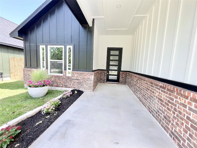 11841 12th St, Santa Fe, TX 77510 - view of exterior entry with brick siding and board and batten siding