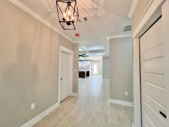 11841 12th St, Santa Fe, TX 77510 - corridor featuring a chandelier, crown molding, and light wood-style flooring