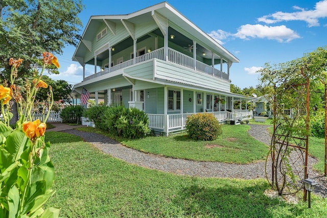 864 N Franklin St, La Grange, TX 78945 - view of home's exterior featuring a balcony, a porch, a lawn, and a ceiling fan