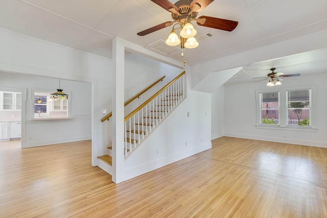864 N Franklin St, La Grange, TX 78945 - unfurnished living room featuring healthy amount of natural light, light wood-style floors, and stairway