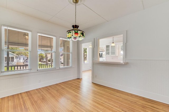 864 N Franklin St, La Grange, TX 78945 - unfurnished dining area with light wood-style flooring and wainscoting