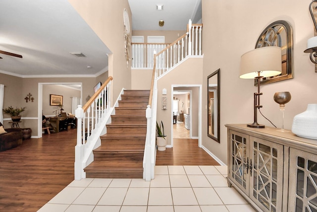 1503 Pine Ridge Ln, Pearland, TX 77581 - staircase featuring ceiling fan, wood finished floors, and crown molding