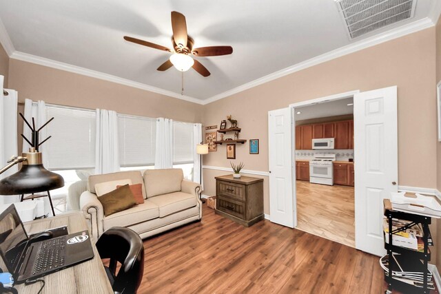 1503 Pine Ridge Ln, Pearland, TX 77581 - living room with wood finished floors, ceiling fan, ornamental molding, and a desk