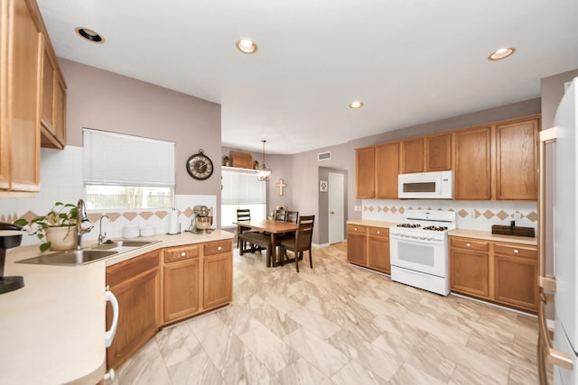 1503 Pine Ridge Ln, Pearland, TX 77581 - kitchen featuring white appliances, tasteful backsplash, light countertops, recessed lighting, and hanging light fixtures