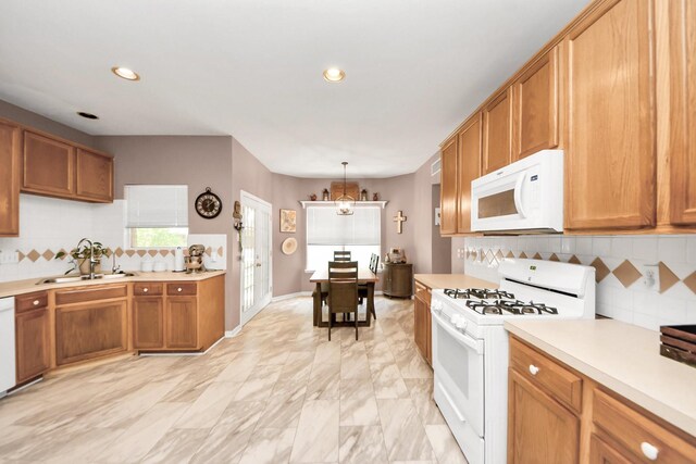 1503 Pine Ridge Ln, Pearland, TX 77581 - kitchen with white appliances, light countertops, brown cabinetry, decorative backsplash, and recessed lighting