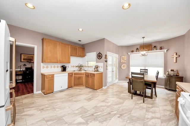 1503 Pine Ridge Ln, Pearland, TX 77581 - kitchen featuring white appliances, a chandelier, light countertops, recessed lighting, and decorative light fixtures