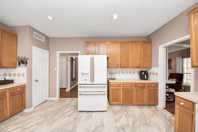 1503 Pine Ridge Ln, Pearland, TX 77581 - kitchen featuring high end white refrigerator, light countertops, tasteful backsplash, and recessed lighting