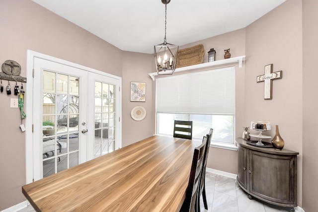 1503 Pine Ridge Ln, Pearland, TX 77581 - dining space with french doors, plenty of natural light, light marble finish floors, and a chandelier