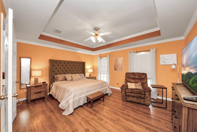 1503 Pine Ridge Ln, Pearland, TX 77581 - bedroom featuring a raised ceiling, dark wood-style flooring, ornamental molding, and a ceiling fan