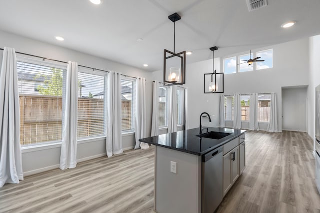 8722 Riverton Ridge Rd, Cypress, TX 77433 - kitchen with dishwasher, dark countertops, plenty of natural light, light wood-type flooring, and recessed lighting