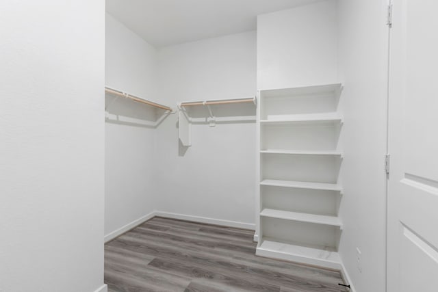 8722 Riverton Ridge Rd, Cypress, TX 77433 - walk in closet featuring wood finished floors