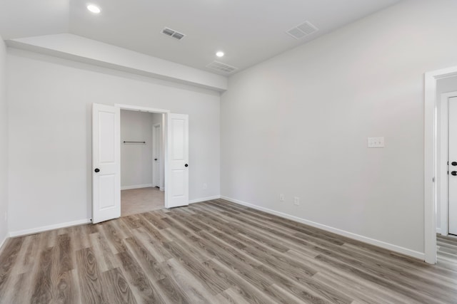 8722 Riverton Ridge Rd, Cypress, TX 77433 - unfurnished bedroom featuring light wood-type flooring and recessed lighting