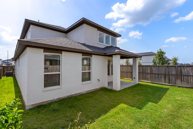 8722 Riverton Ridge Rd, Cypress, TX 77433 - back of house with brick siding, a fenced backyard, a patio, roof with shingles, and stucco siding