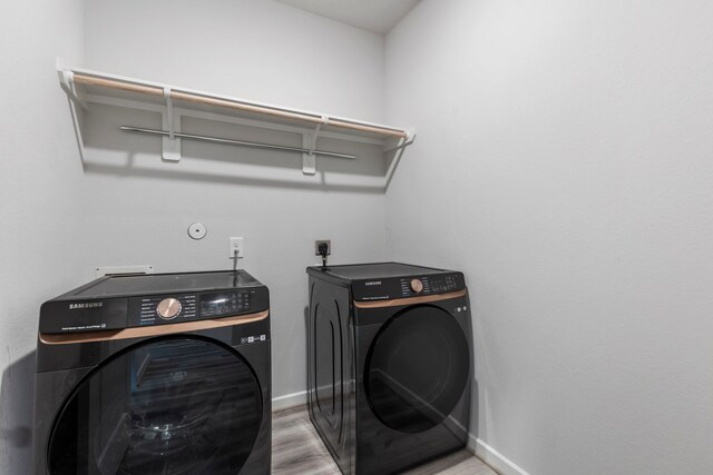 8722 Riverton Ridge Rd, Cypress, TX 77433 - washroom with independent washer and dryer and wood finished floors