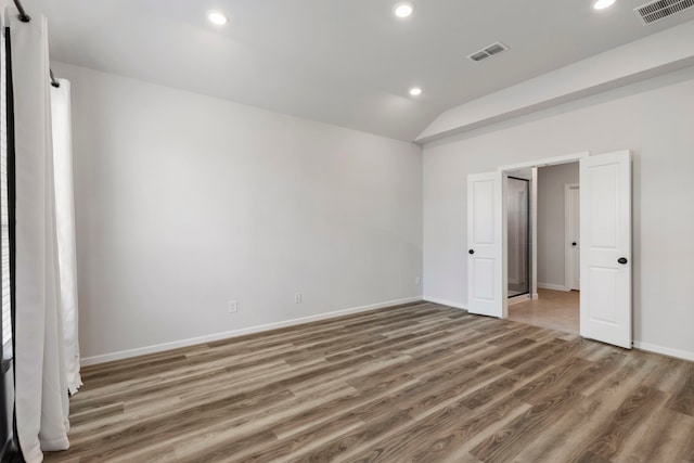 8722 Riverton Ridge Rd, Cypress, TX 77433 - unfurnished bedroom featuring wood finished floors, recessed lighting, and lofted ceiling