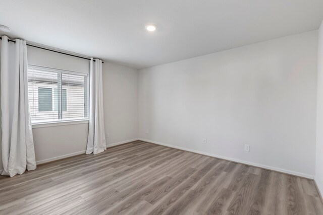 8722 Riverton Ridge Rd, Cypress, TX 77433 - spare room featuring light wood finished floors and baseboards