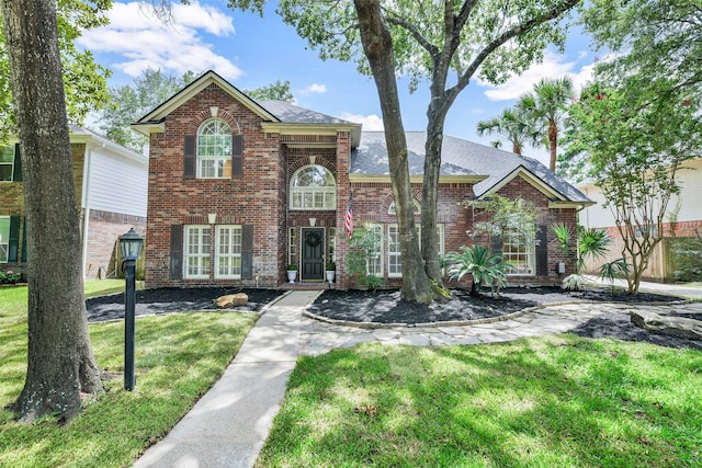 12911 Bristol Berry Dr, Cypress, TX 77429 - view of front of home with brick siding, a front yard, and roof with shingles