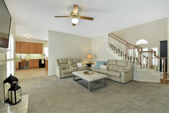 12911 Bristol Berry Dr, Cypress, TX 77429 - living area featuring stairway, light carpet, and a ceiling fan