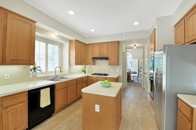 12911 Bristol Berry Dr, Cypress, TX 77429 - kitchen with stainless steel fridge, dishwasher, gas cooktop, a kitchen island, and light wood finished floors
