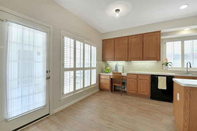 12911 Bristol Berry Dr, Cypress, TX 77429 - kitchen featuring dishwasher, built in study area, light countertops, brown cabinets, and light wood-style flooring