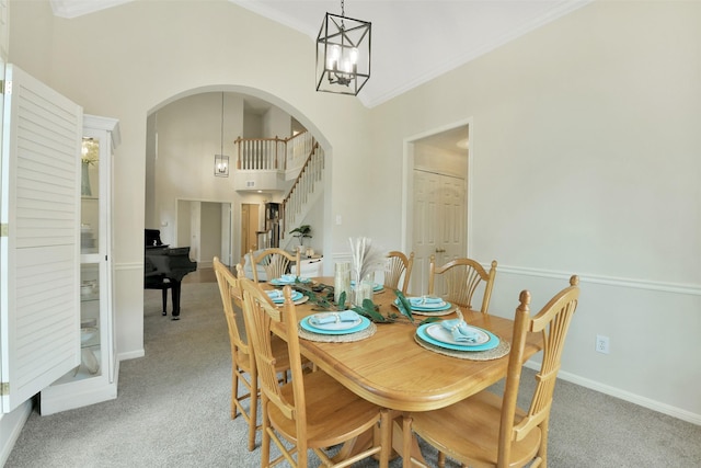 12911 Bristol Berry Dr, Cypress, TX 77429 - dining room with light carpet, a chandelier, arched walkways, ornamental molding, and stairs