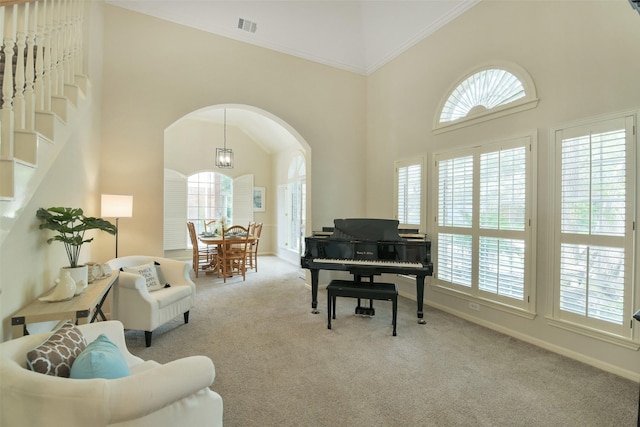 12911 Bristol Berry Dr, Cypress, TX 77429 - living area with carpet floors, healthy amount of natural light, arched walkways, a high ceiling, and crown molding