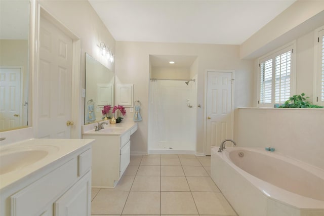 12911 Bristol Berry Dr, Cypress, TX 77429 - full bath featuring a stall shower, a bath, two vanities, and tile patterned floors