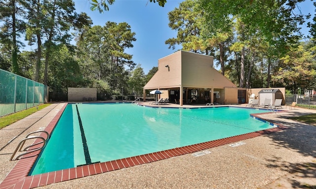 12911 Bristol Berry Dr, Cypress, TX 77429 - community pool with a shed, view of scattered trees, a patio area, and a gazebo