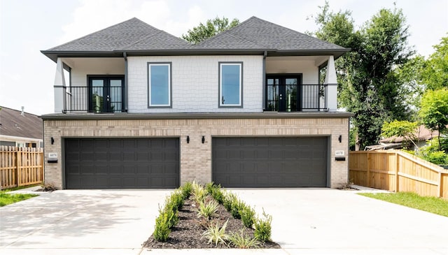 4417 Aledo St, Houston, TX 77051 - view of front of home featuring a balcony, a garage, driveway, and roof with shingles