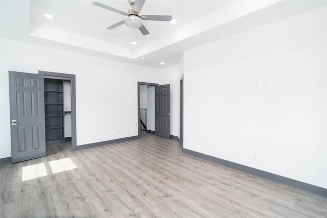 4417 Aledo St, Houston, TX 77051 - spare room featuring light wood-type flooring, recessed lighting, a ceiling fan, and a raised ceiling