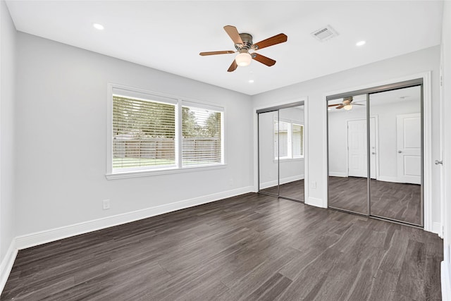 639 Ames St, Spring, TX 77373 - unfurnished bedroom featuring dark wood finished floors, two closets, ceiling fan, and recessed lighting